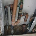 Leaking Copper Supply Line Manifold Inside Wall Behind Water Heater/Boiler