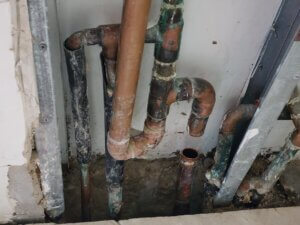 Leaking Copper Supply Line Manifold Inside Wall Behind Water Heater/Boiler