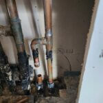 Leaking Copper Pipe in Manifold Inside Bathroom Wall. Line Cap Off Temporally