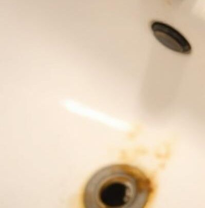 Interior view of a bathroom faucet and pipe showing early mold growth caused by moisture and organic buildup inside residential plumbing.