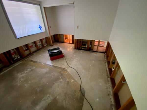 Tip Top Plumbing Company drying a flooded residential area in Broward County, FL, using industrial dehumidifiers and air movers to remove moisture and restore the space after plumbing-related water damage.