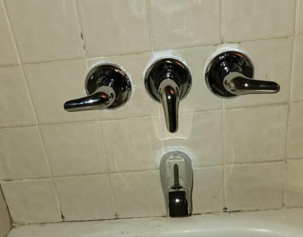 Professional bathroom plumbing installation by Tip Top Plumbing in Broward County, featuring precise under-sink pipework, water lines, and modern fixtures.