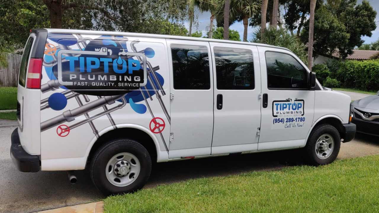 Tip Top Plumbing & Restoration branded service van, featuring clear company branding and contact information, parked in a residential area in Broward County, FL.