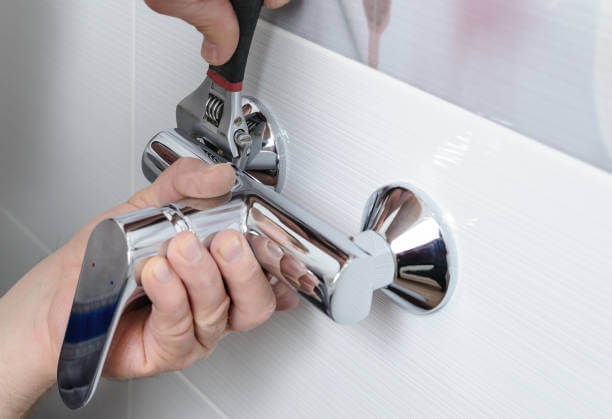 Tip Top Plumbing & Restoration performs expert faucet repairs in Lazy Lake, FL. This image shows a wall-mounted chrome faucet being securely adjusted during a professional plumbing service.