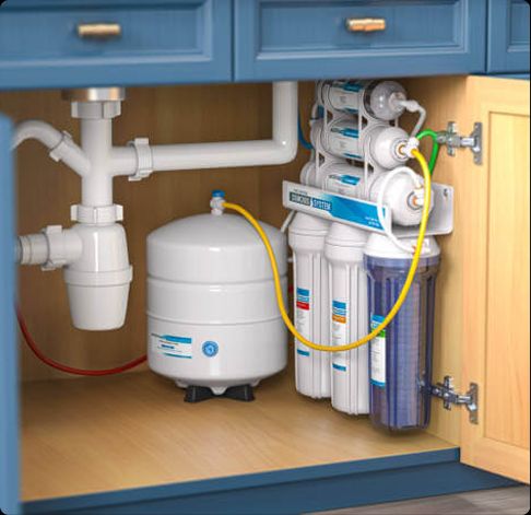 Tip Top Plumbing & Restoration in Lighthouse Point FL installs high-efficiency under-sink water filtration systems. This image shows a clean residential setup with reverse osmosis filters and tank.
