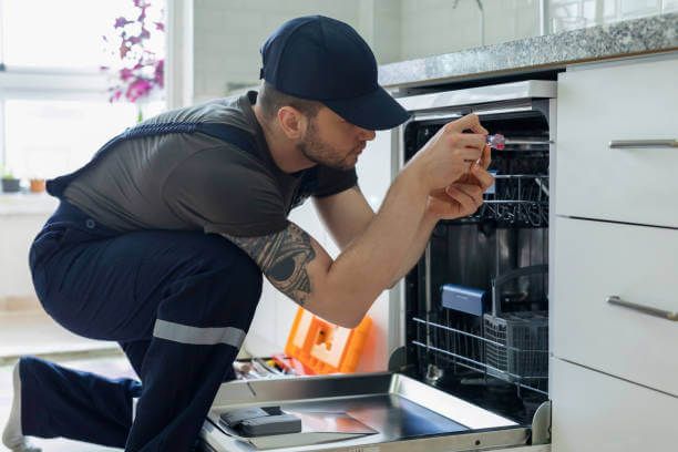 Tip Top Plumbing & Restoration in Miramar FL provides expert dishwasher plumbing and installation services. This image shows a technician performing a dishwasher repair in a residential kitchen.