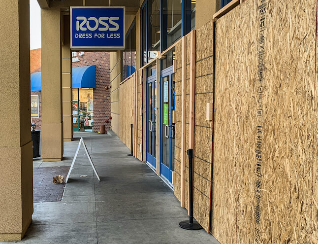 Boarded-up storefront at Ross after damage, secured by Tip Top Plumbing & Restoration in Sunshine Acres FL